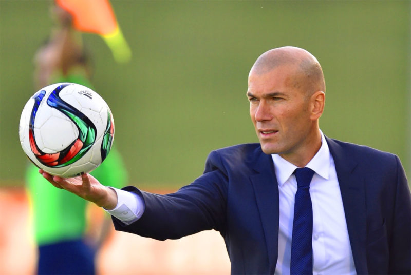 Zinedine Zidane holding a ball 