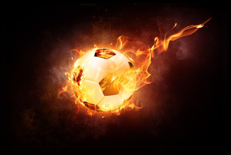 Football on fire with black background