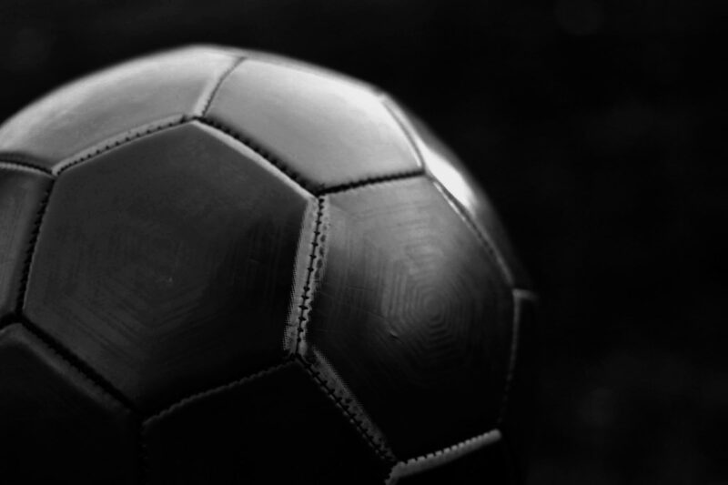 A Black football with a black background