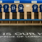 A picture of blue football jerseys hung up in a locker room.