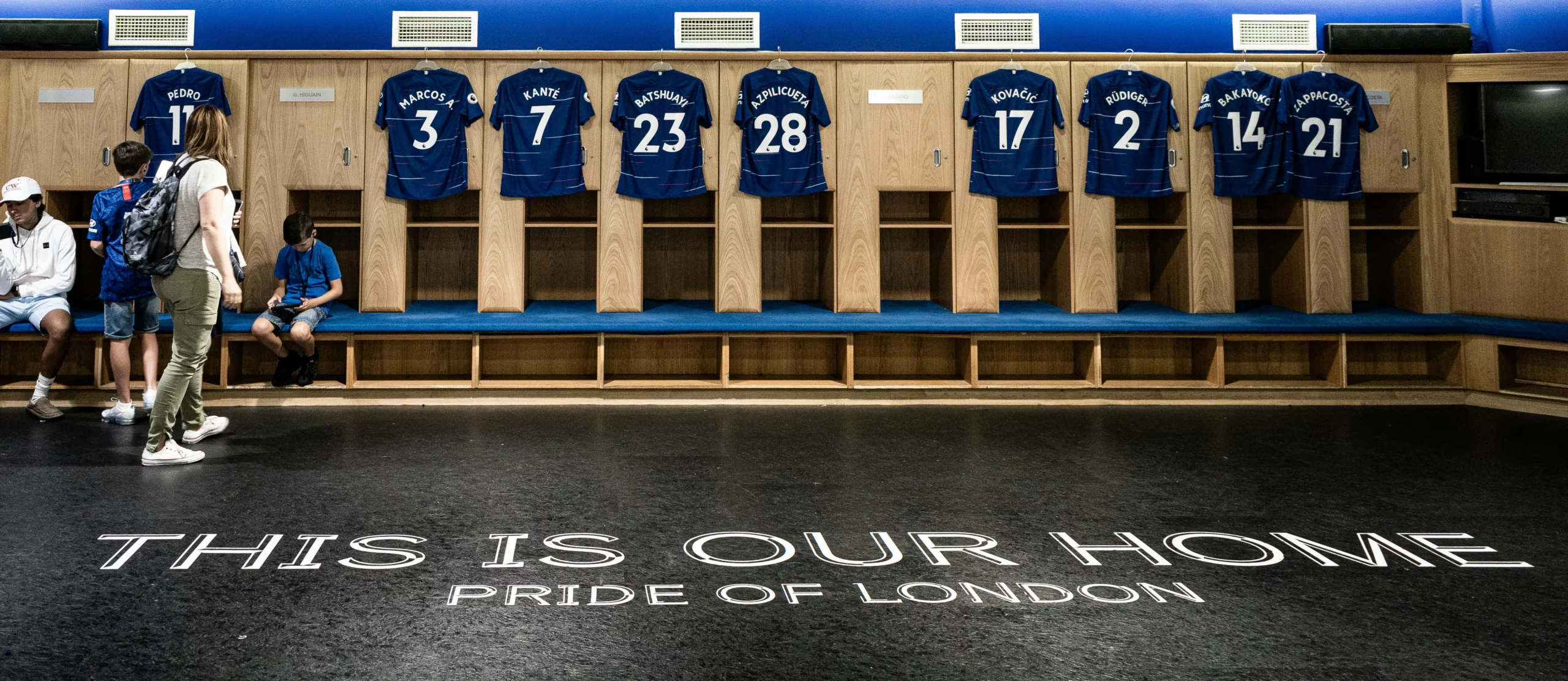 A picture of blue football jerseys hung up in a locker room.