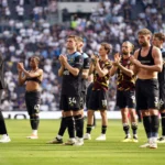 Burnley players alongside manager Vincent Kompany stand dejected after their relegations was confirmed