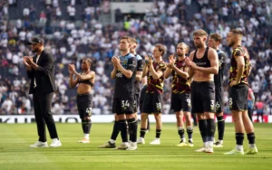 Burnley players alongside manager Vincent Kompany stand dejected after their relegations was confirmed