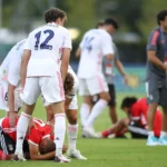 Real Madrid players and coach Raul Gonzalez Blancotry to comfort the devastated Benfica players