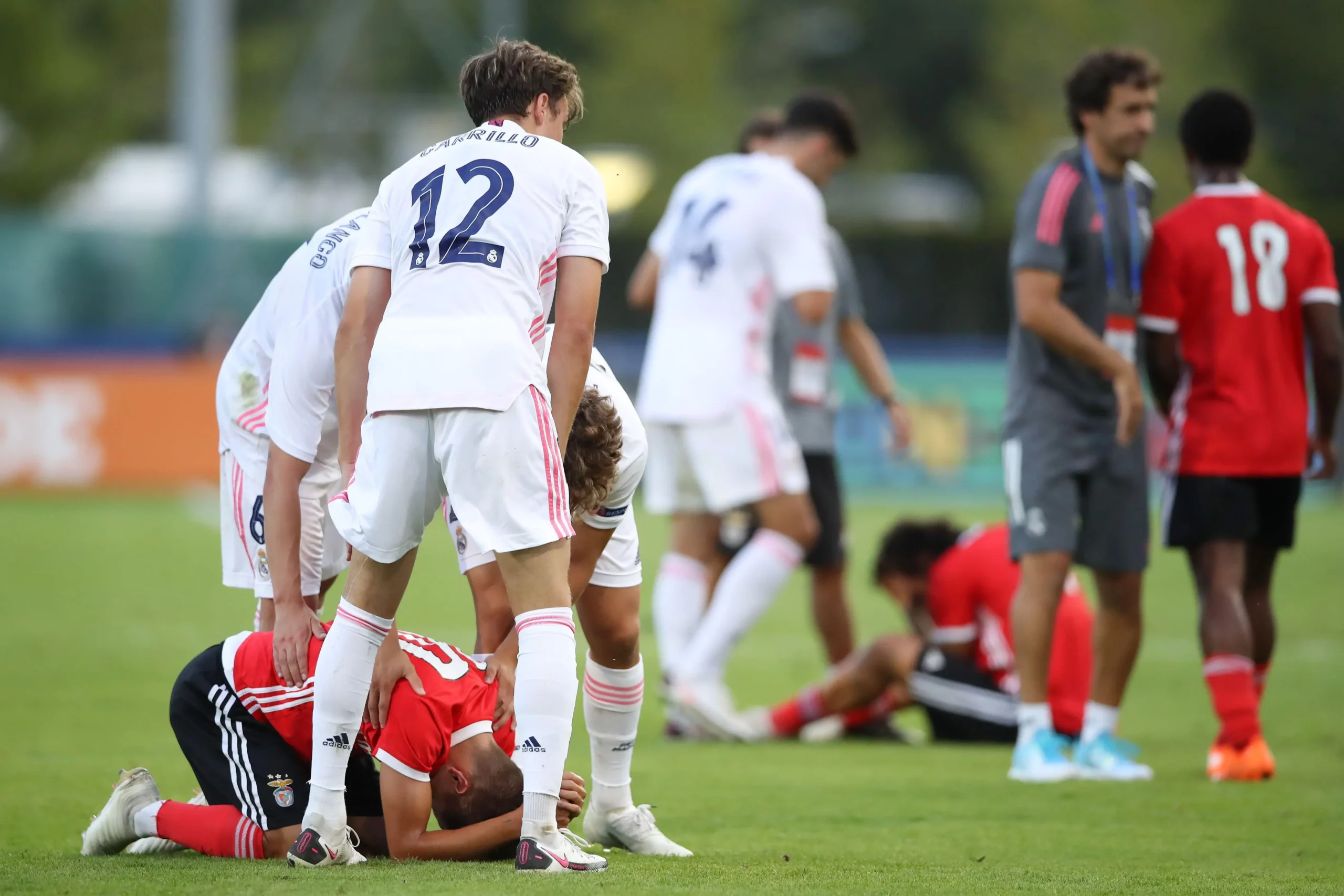 Real Madrid players and coach Raul Gonzalez Blancotry to comfort the devastated Benfica players