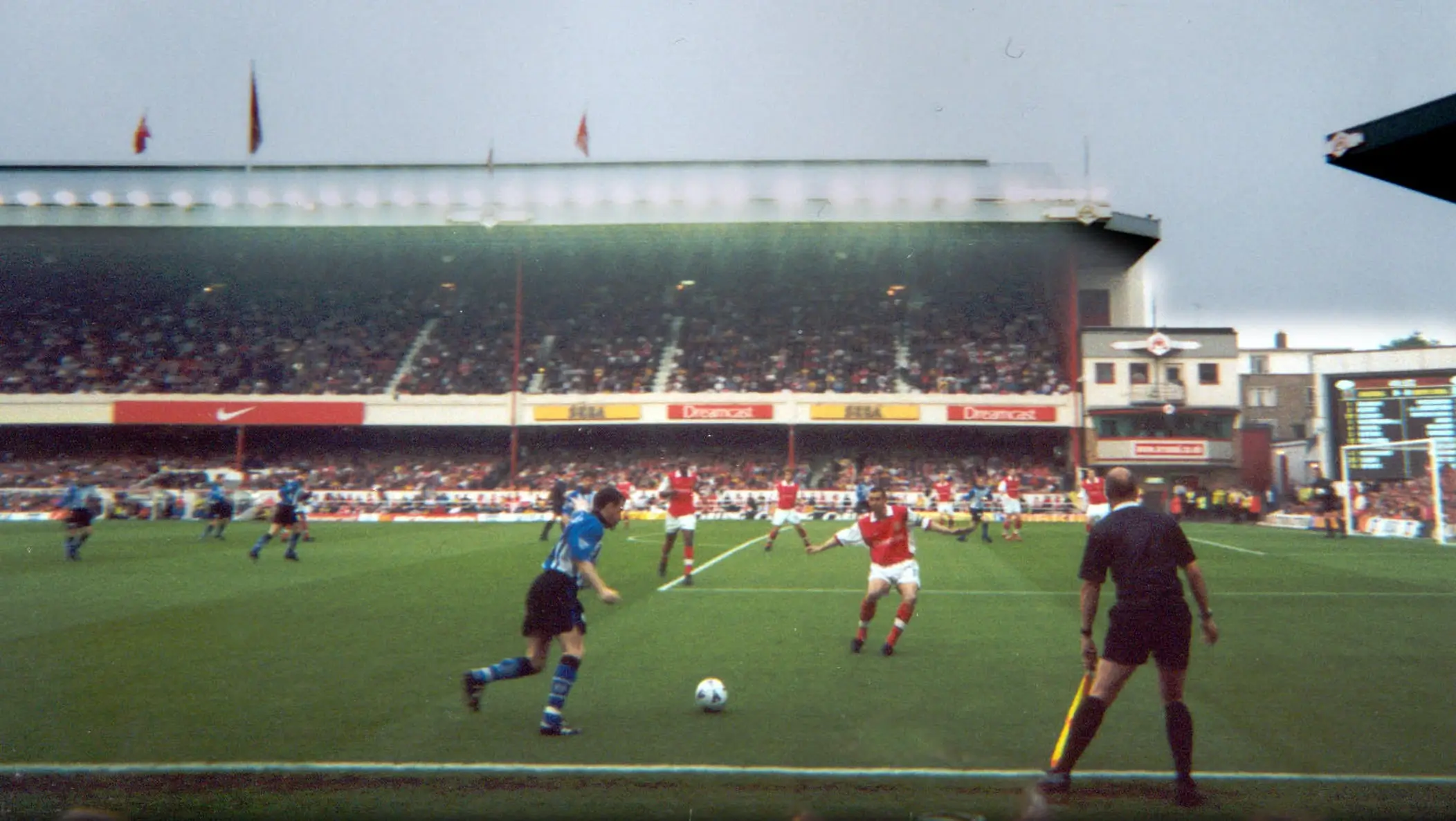 This image features a match between Arsenal and Sheffield Wednesday, two prominent football clubs in England. It captures the intensity of the match during a 2000s football season.